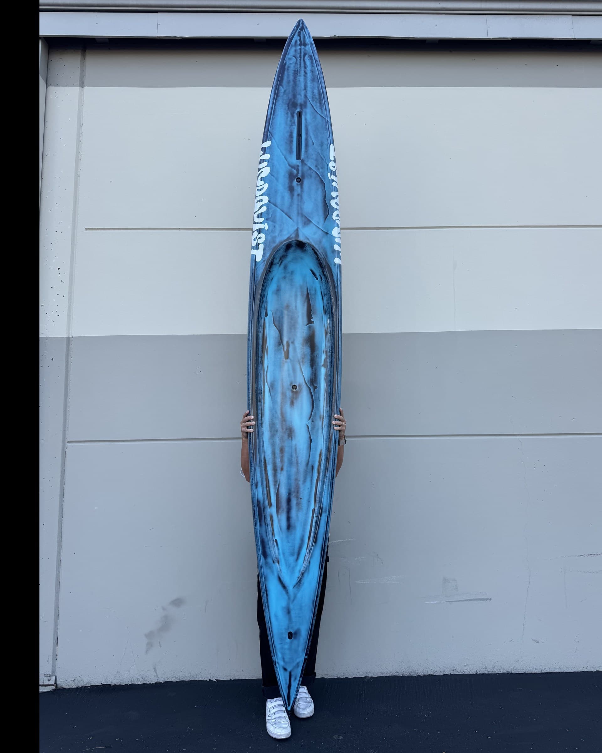 Deck of a custom Lundquist prone paddleboard, recessed deck channel and hand-painted blue resin tint.